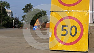 Road sign speed limit 50 km h in combination with road work ahead. Warning signs for work in progress on closed road