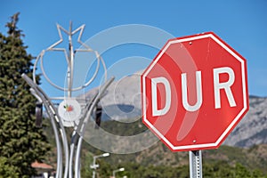 The road sign STOP in Turkish DUR is prohibited in Turkey in front of mountains.