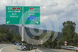 Road sign of the Swiss highway with directions to reach European cities photo