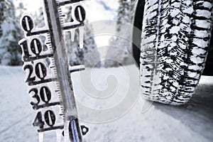 Road sign and thermometer with sub-zero temperatures warn of snow