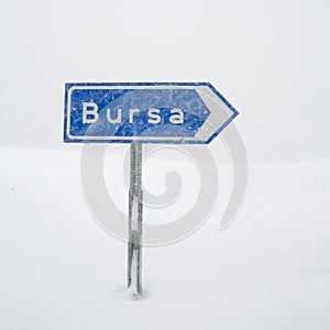 Road sign to Bursa under snow in Uludag