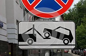 Road sign of tow truck evacuator with reflective layer on the streets of Moscow