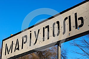 Road sign of the Ukrainian city Mariupol, Donetsk region, punched by bullets during the war, Ukraine