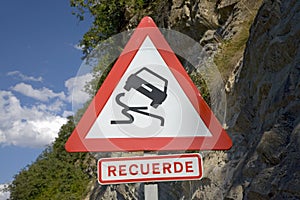 Road sign warning of falling rocks in Pyrenees Mountains, Province of Huesca, Spain