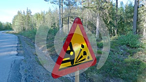 A road sign warning of loose stone chippings on the road