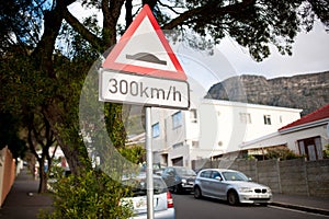 Road sign, warning and red triangle signage in street for speedbump with caution notification and speed limit. Attention