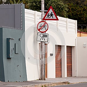 Road sign, warning and signage in street for pedestrian with caution notification or neighborhood outdoor in city