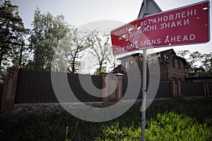 A road sign was damaged by shrapnel from shelling by Russian troops.