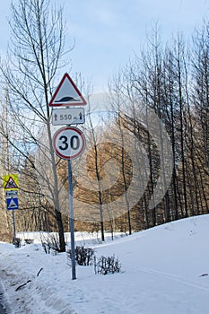 Road Sign on a winter day. Winter forest landscape behind