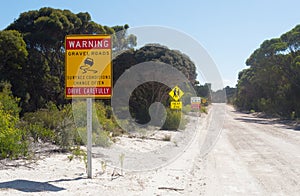 Road signs along dirt road