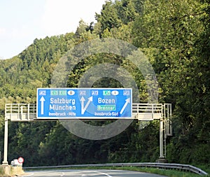Traffic signs with directions to cities and state borders on the photo