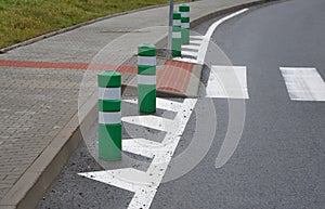Road signs drawn on the road side. zebra where he must not stop and park. asphalt with the support of green plastic posts. These p