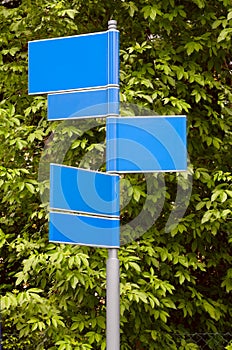 Road signs with a green leaves background