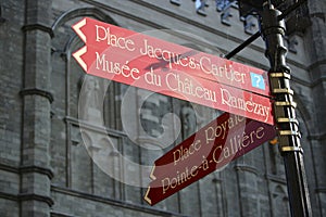 Road Signs of Montreal City, background is Notre-Dame Basilica of Montreal. Four signs means respectively: Place Jacques-Cartier,