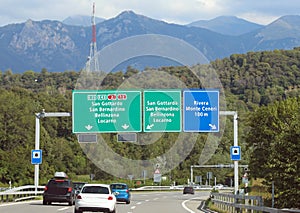 road signs on the motorway with directions to many locations in Switzerland near the Italian border photo