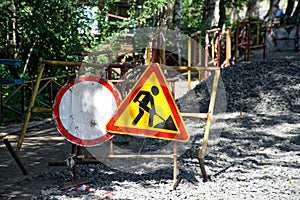 Road signs prohibiting travel to the site of excavation. Repair and replacement of underground utilities in the city