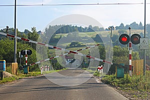 Road signs at the railway crossing with a barrier. Organization of the transport system of a European country. Red white coloring