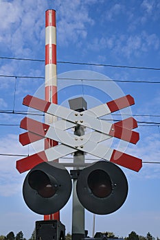 Road signs at the railway crossing with a barrier. Organization of the transport system of a European country. Safety of traffic