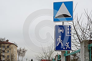 Road signs `Residential area` and `Speed bump`