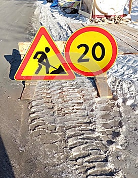 Road signs. Road works are ahead. A warning sign. Round road sign with the number 20