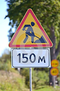 Road signs Roadwork, Distance of 150 m against greens