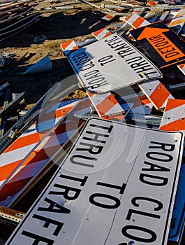 Road signs stacked among construction debris
