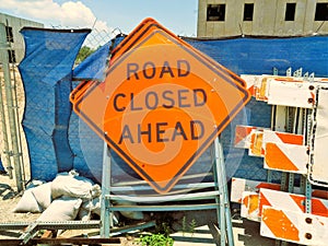 Road signs stacked at construction site.