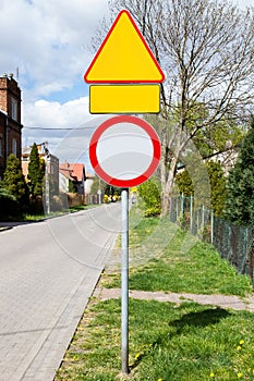 Road signs on the street along the road empty for inscriptions.