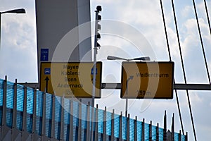 road signs on suspension bridge RaiffeisenbrÃ¼cke across the Rhine