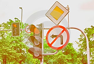 Road signs, the traffic light is red, the turn to the left is forbidden
