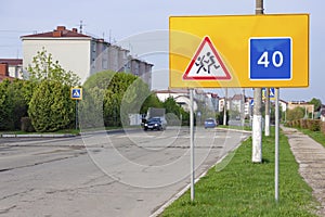 Road signs warning of children and recommended speed