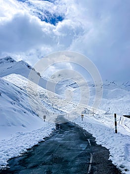 Road in the snow between snowy mountains