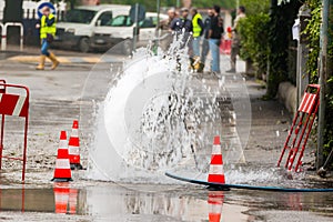 Road spurt water beside traffic cones photo