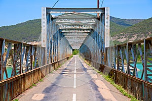 Road and steel bridge over reservoir