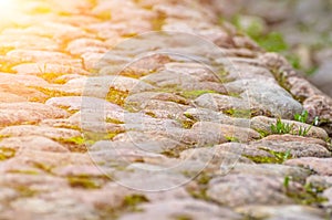 Road from stones paving stone and grass