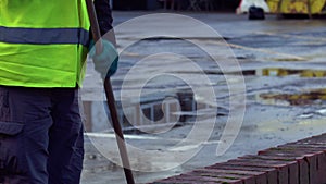 Road sweeper using a broom to sweep road