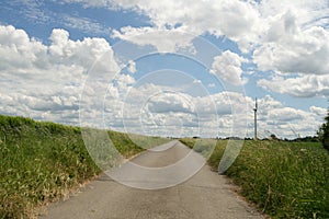 A road with a tall windmill in the background