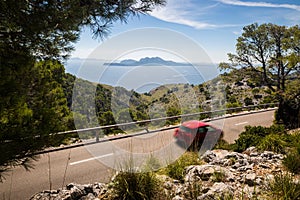Road to Cap Formentor with red motion blurred car
