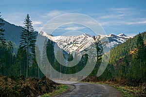 Road to famous Chocholowska Clearing with snowcapped mountains in the background, Tatra Mountains, Poland