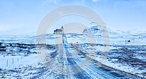 Road to Ingjaldsholl Church during snowstorm, close to Hellissandur, Snaefellsnes peninsula, Iceland photo