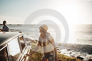 The road to love is a scenic one. a young couple enjoying a road trip along the coast.