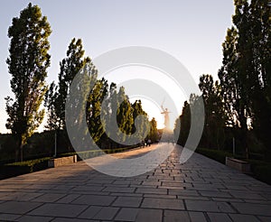 The road to Mamayev Kurgan in Volgograd in the sunset and the silhouette of the monument Motherland calls in the distance