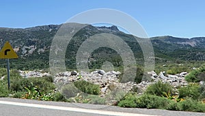 Road to mountain village Krasi on Crete /Greece. Driving along a road with olive trees aside