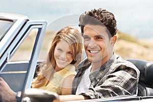 Road to nowhere. An attractive young man driving a sports car with his girlfriend next to him.