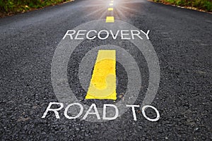 Road to recovery word on asphalt road surface with marking lines photo