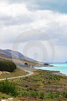 Road to the Southern Alps. Along the shore of the turquoise lake Pukaki. New Zealand