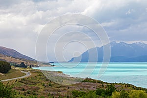 Road to the Southern Alps. Along the shore of the turquoise lake Pukaki. South Island, New Zealand