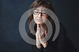 The road to success wont always be easy to navigate. Studio shot of a corporate businesswoman posing against a dark