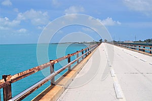 Road to tropical water paradise over a long bridge.