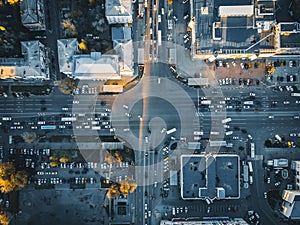 Road traffic on crossroad or intersection downtown of European city, aerial or top view